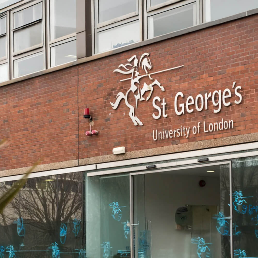 Entrance view of St George's, University of London building. It stands out with its modern architecture and open door.